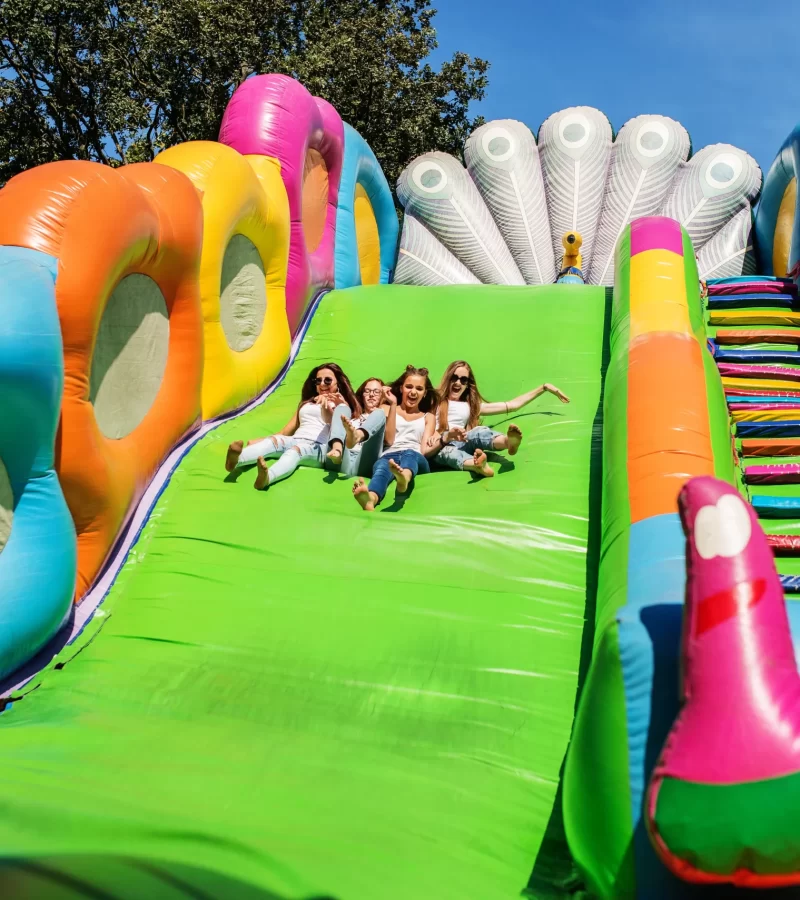 Teens enjoying a slide of the inflatable bouncing slide.